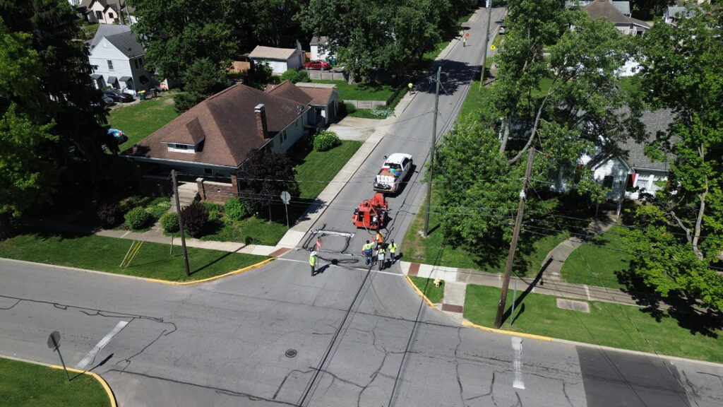 Aerial view of an HSC crew performing roadway maintenance at a residential street intersection in Indiana